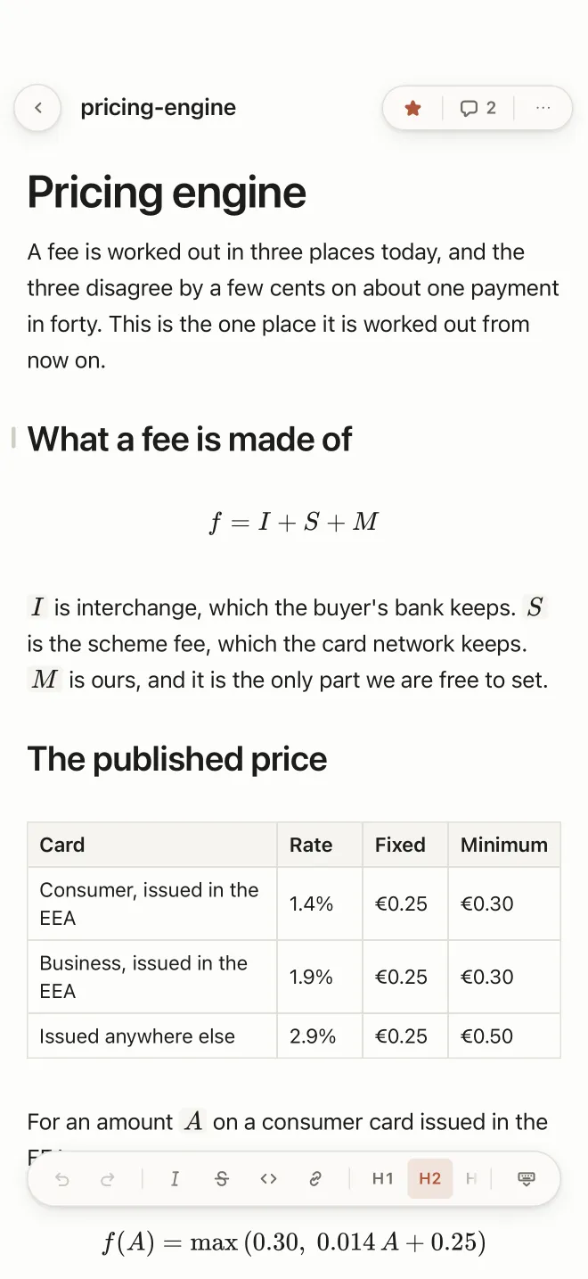 A pricing document open on the phone, with a heading, a formula, a table of card rates and the formatting strip at the foot showing H2 selected.